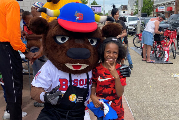 Kid posing with Buster Bison
