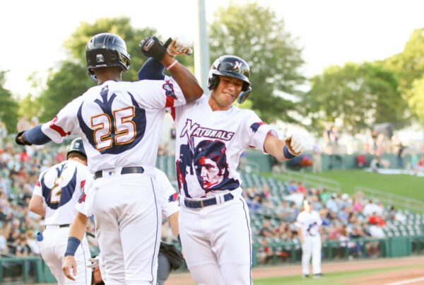 Two NWA players bump arms in celebration