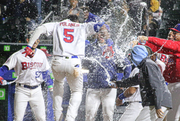 Bisons players celebrate, spraying water from bottles