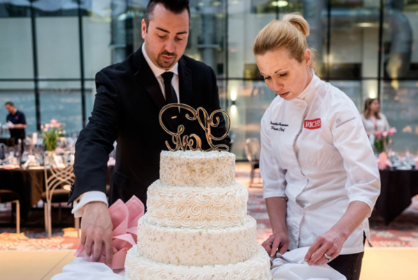 Rich's Catering associates prepare a tiered cake at an event