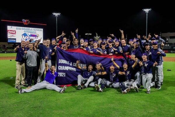 NWA team poses on field with Double-A champions banner