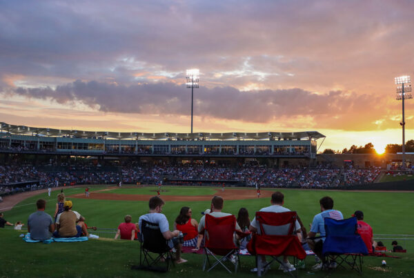Spectators in camping chairs and blankets in the outfield at Arvest Ballpark