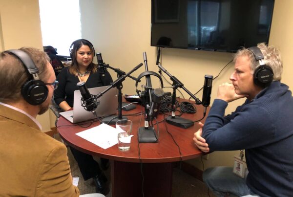 Associates around a table recording a podcast